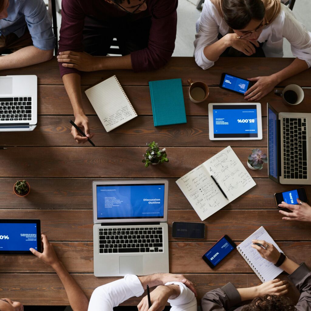 Top View Photo Of People Near Wooden Table